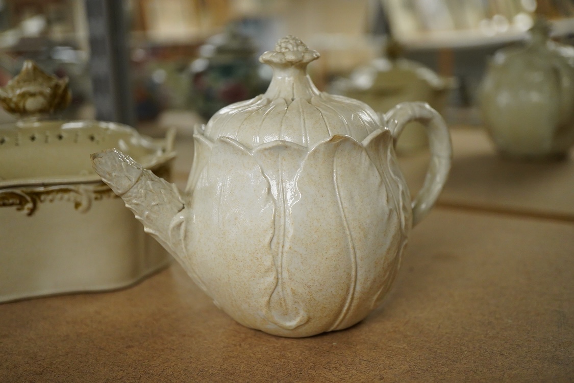 A rare Staffordshire saltglaze stoneware teapot, mid 18th century, an early 19th Wedgwood stoneware teapot and a stoneware butter tub and cover - 13cm wide (3)